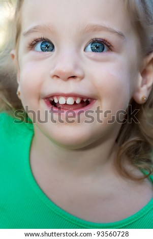 Portrait of a beautiful baby girl with beautiful blue eyes smiling
