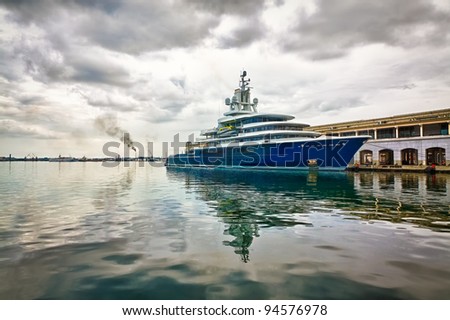 Modern scientific research or tourism ship docked in a pier with a violent storm approaching