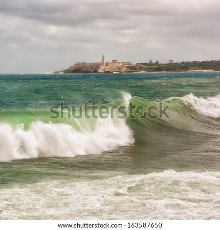 The castle of El Morro with big sea waves in the foreground during a tropical cyclone in Havana