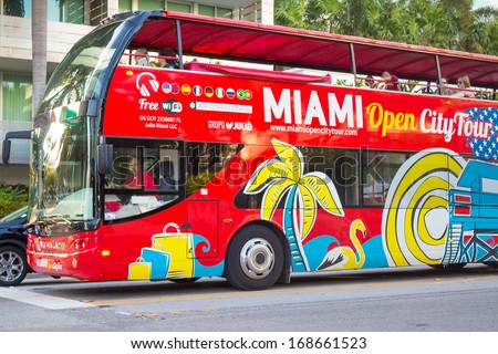 MIAMI,US - NOVEMBER 24,2013:Open deck sightseeing bus at Miami Beach. International tourists make up 48% of all visitors and contribute at least $2.9 billion to the Miami economy