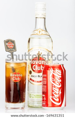 HAVANA,CUBA - DECEMBER 25, 2013:Havana Club rum bottle and coke can next to a Cuba Libre coktail.Established in Cuba in 1878, Havana Club is the world\'s No.3 rum brand and a symbol of cuban culture