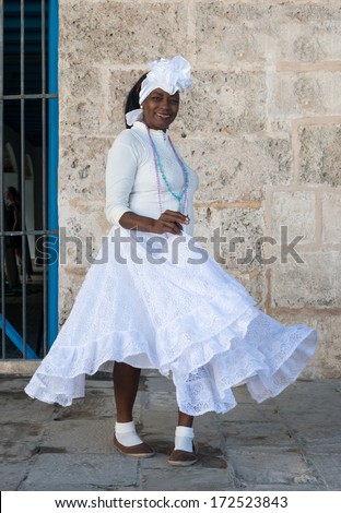 HAVANA,CUBA - JANUARY 20, 2014:Afro woman dressed with typical clothes.Characters like this are common in the streets of Old Havana and a photo opportunity for the growing number of foreign tourists