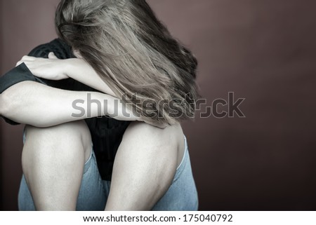 Emotional image of a sad and lonely woman crying (with space for text)