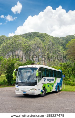 VINALES, CUBA - APRIL 15, 2014: Tour bus at the Vinales Valley in Cuba, a famous touristic landmark worldwide known for its unique natural beauty and the quality of its tobacco plantations