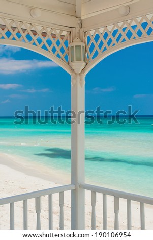 View of Varadero beach in Cuba framed by the columns of a beautiful wooden terrace