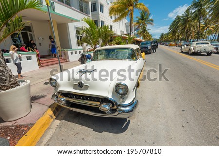 MIAMI,USA - MAY 21,2014 : Vintage car parked at Ocean Drive in Miami Beach, Florida. Art Deco architecture in South Beach is one of the main tourist attractions in Miami