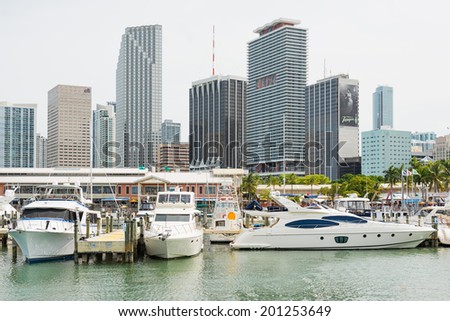MIAMI,USA - MAY 27,2014 : The Bayside Marketplace in downtown Miami with a view of the yachts docked at the site and the skyscrapers surrounding the area