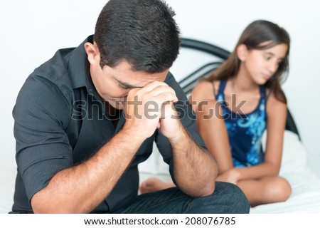 Worried young father with her troubled teenage daughter