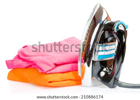 Iron, small home  electrical appliance,  with colorful clothes isolated on a white background