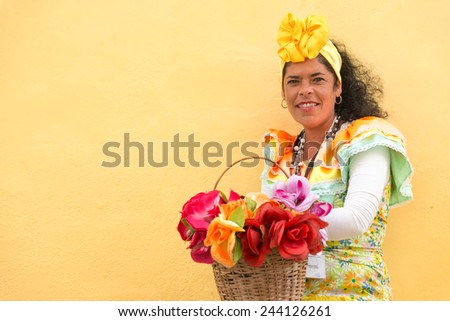 HAVANA, CUBA - JANUARY 8, 2015 : Young latin woman wearing a traditional dress in Old Havana