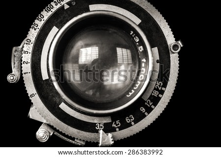 Vintage camera lens close-up isolated on black