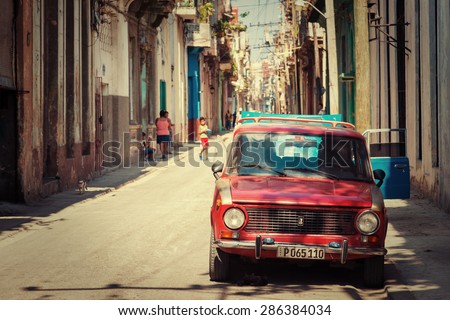 HAVANA,CUBA - MAY 30,2015 : Old russian car on a typical neighborhood with decaying buildings in Old Havana