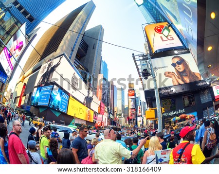 NEW YORK,USA - AUGUST 14,2015 : Tourists and locals crowd at famous Times Square in New York City