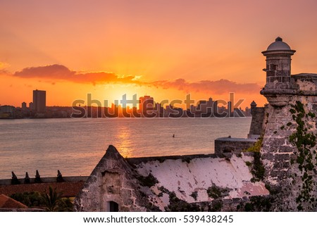 Beautiful sunset in Havana with a view of the city skyline and the sun setting over the buildings - Seen from an El Morro castle across the bay