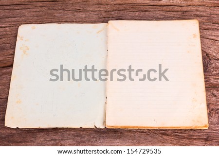 old opened softcover book with empty pages on wooden background