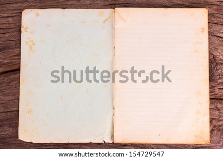 old opened softcover book with empty pages on wooden background
