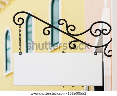 white rectangle shop sign hanging on the wall