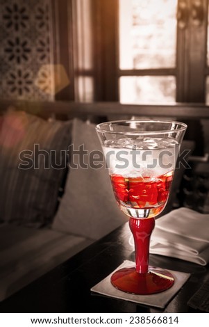 Red Glass Of Water On The Table With Sun Light : Selective Focus With Filtered Process