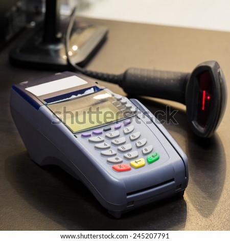 Credit Card Machine with Barcode Scanner in Background at the store