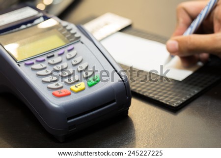 Color Buttons on Credit Card Machine With Signing Transaction In Background : Selective Focus