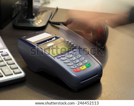 Motion of Hand Swiping Credit Card In Store