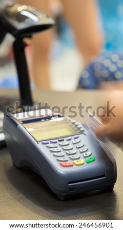 Motion of Hand Swiping Credit Card In Store : Selective Focus