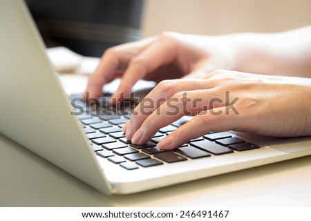 Woman\'s hands typing on laptop keyboard : Selective Focus