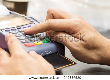 Close Up Of Hand With Credit Card Swipe Through Terminal For Sale In Store
