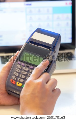 Hand With Credit Card Swipe Through Terminal For Sale In Store