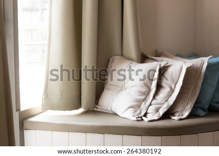 Pillows On Build-In Sofa In The Living Room With Sunlight From The Window