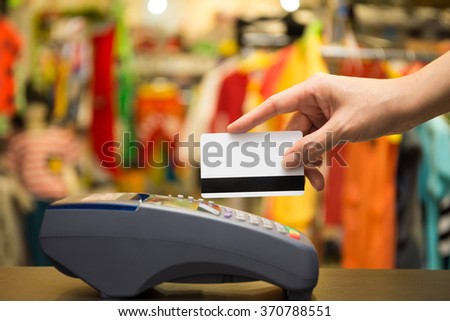 Hand Swiping Credit Card In Store