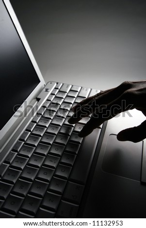 Vertically framed shot of fingers on a laptop keyboard