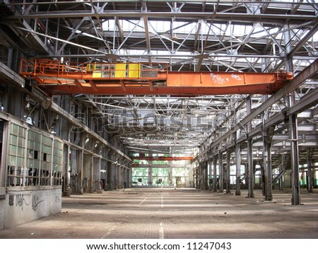 An indoor shot of an abandoned factory made with silver painted steel i-beams.