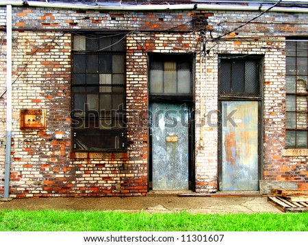 Two doors in the sides of old, run-down buildings