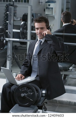 Young, attractive businessman working at the gym