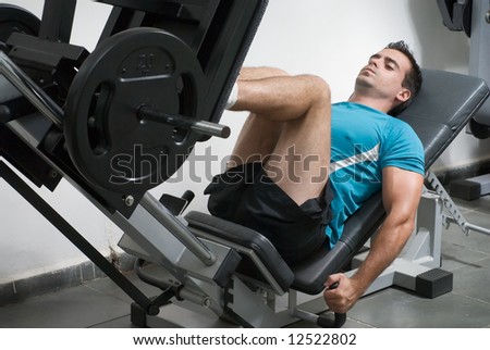 Male weightlifter doing leg presses.