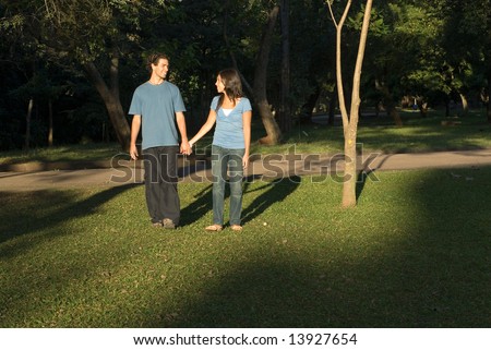 Couple holding hands walking in the 