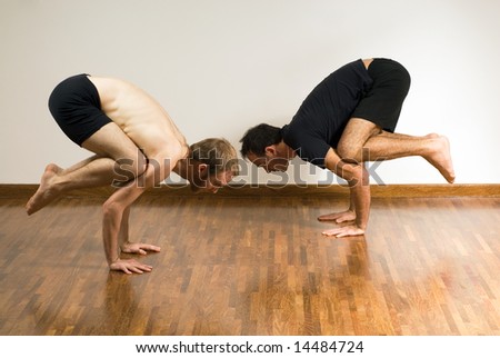 Two men in a yoga crouch