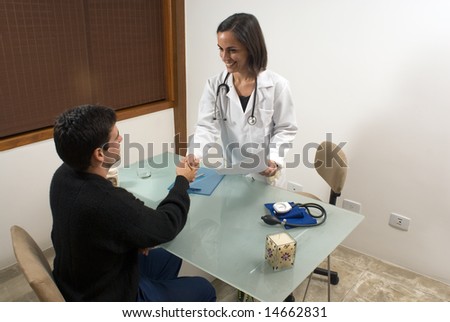 A female doctor is smiling and shaking hands with her patient.  The doctor and the patient are looking at each other.  Horizontally framed photo.