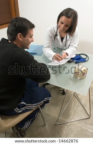 A doctor is showing some information to her patient.  They are both smiling and looking at the paper.  Vertically framed photo.