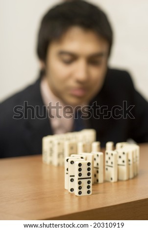 Man playing dominoes. Vertically framed photo.