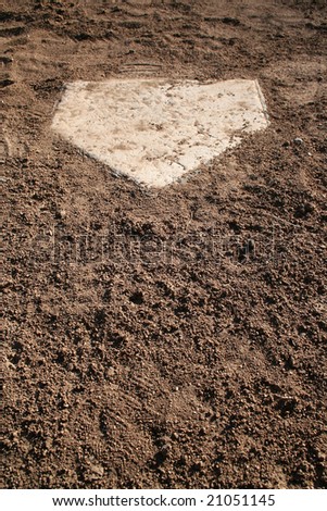 A view of home plate on a baseball diamond. Horizontally framed shot.