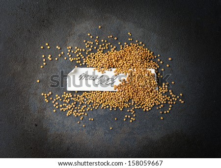 A handful of mustard seeds with manually signed paper label