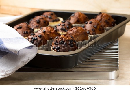 Chocolate muffins on a black metal tray