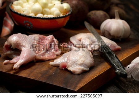 Raw quail cutlets with small onion, garlic and beetroot