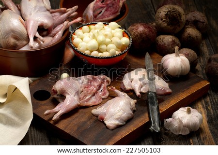 Raw quail cutlets with small onion, garlic and beetroot