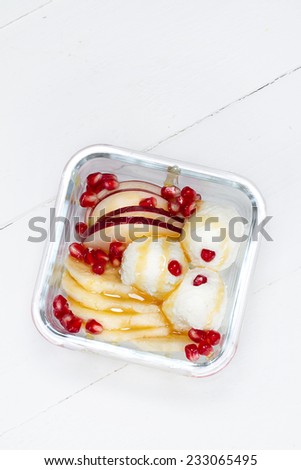 Kids lunch box: cottage cheese, banana, apple, pomegranate seeds and agave syrup