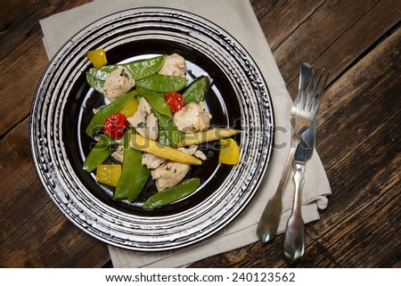 Braised chicken breast with young peas, corn, bell pepper, thyme and cherry tomatoes
