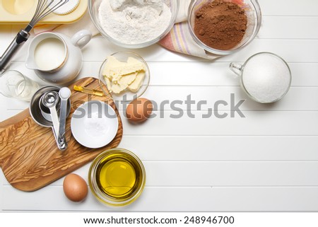 Muffin ingredients: milk, flour, sugar, eggs, butter, olive oil, cocoa powder, baking soda, vanilla extract and vinegar