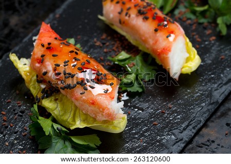 Red king crab, lettuce, parsley, sweet chili, black sesame seeds and azalea seeds appetizer - selective focus